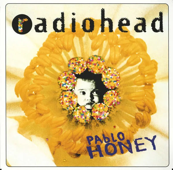 Album cover for 'Pablo Honey' by Radiohead featuring a yellow flower with a face in the center.