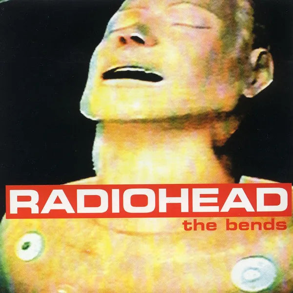 Album cover for Radiohead's 'The Bends' with a dummy's face and album text.
