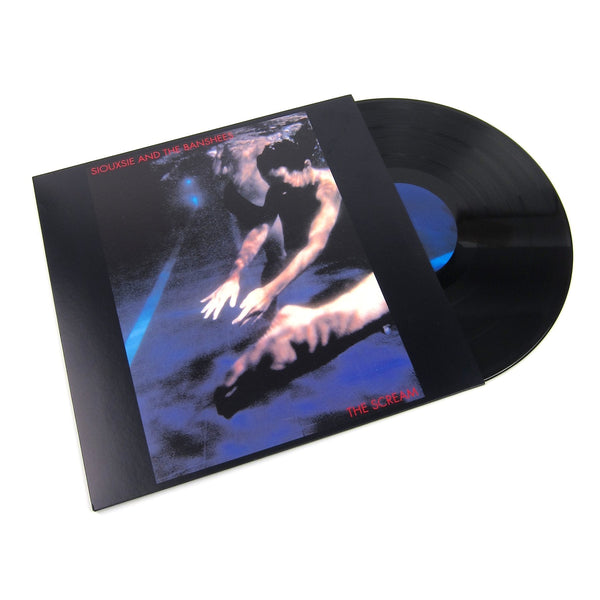 A vinyl LP of Siouxsie And The Banshees - The Scream with a black and blue cover featuring people under water