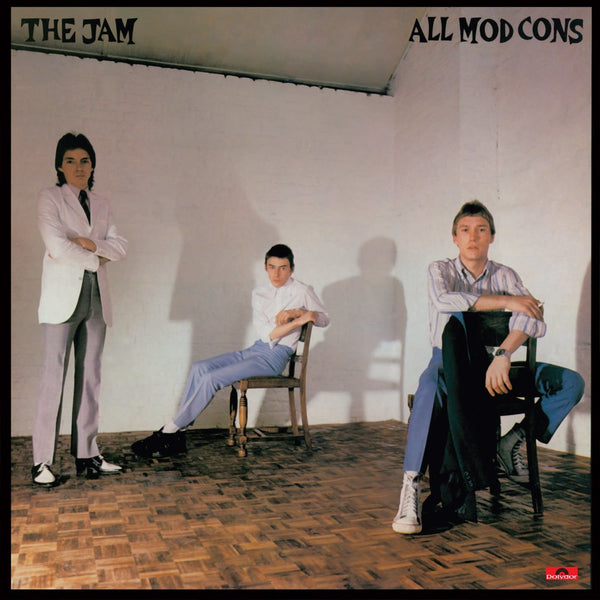 The Jam All Mod Cons album cover featuring the band members in a studio setting with a white background.