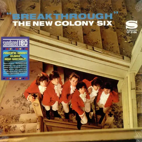 Album cover for 'Breakthrough' by The New Colony Six with the band in red jackets on a staircase.