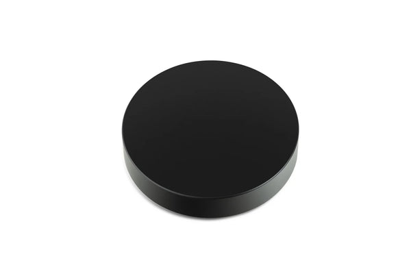 A black Pro-Ject record puck designed to secure a vinyl record to a turntable.