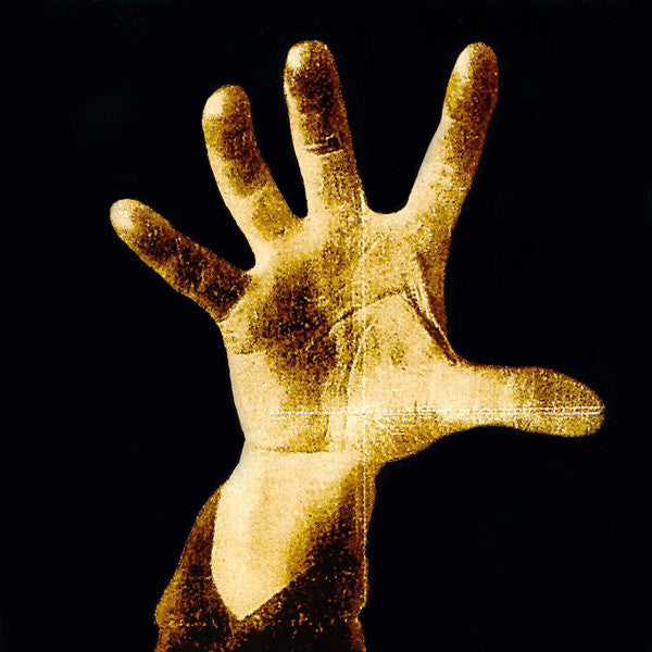 A vinyl record sleeve featuring a hand print in a yellowish hue against a dark background, representing the band System Of A Down.