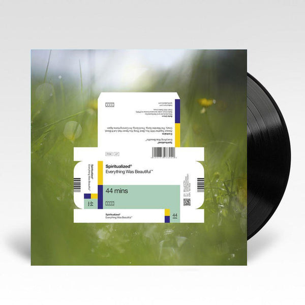 A vinyl LP record of Spiritualized's album 'Everything Was Beautiful' with a white and green cover, depicting a serene landscape
