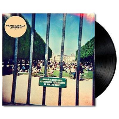 A vinyl record of Tame Impala's album 'Lonerism' with a colorful album cover featuring a park scene.