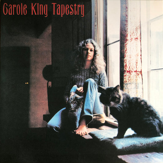 Tapestry by Carole King shows Carole, sitting on a windowsill with her cat beside her, looking towards the camera.