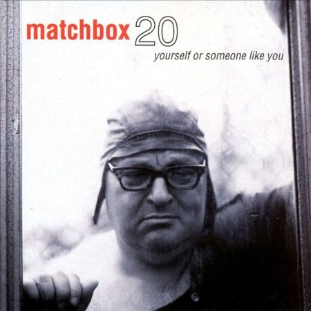 Matchbox 20 album cover featuring a black and white photo of a person with glasses, with the album title 'Yourself Or Someone Like You' displayed.