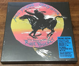Album cover of Neil Young and Crazy Horse's 'Way Down in the Rust Bucket' on a wooden surface.