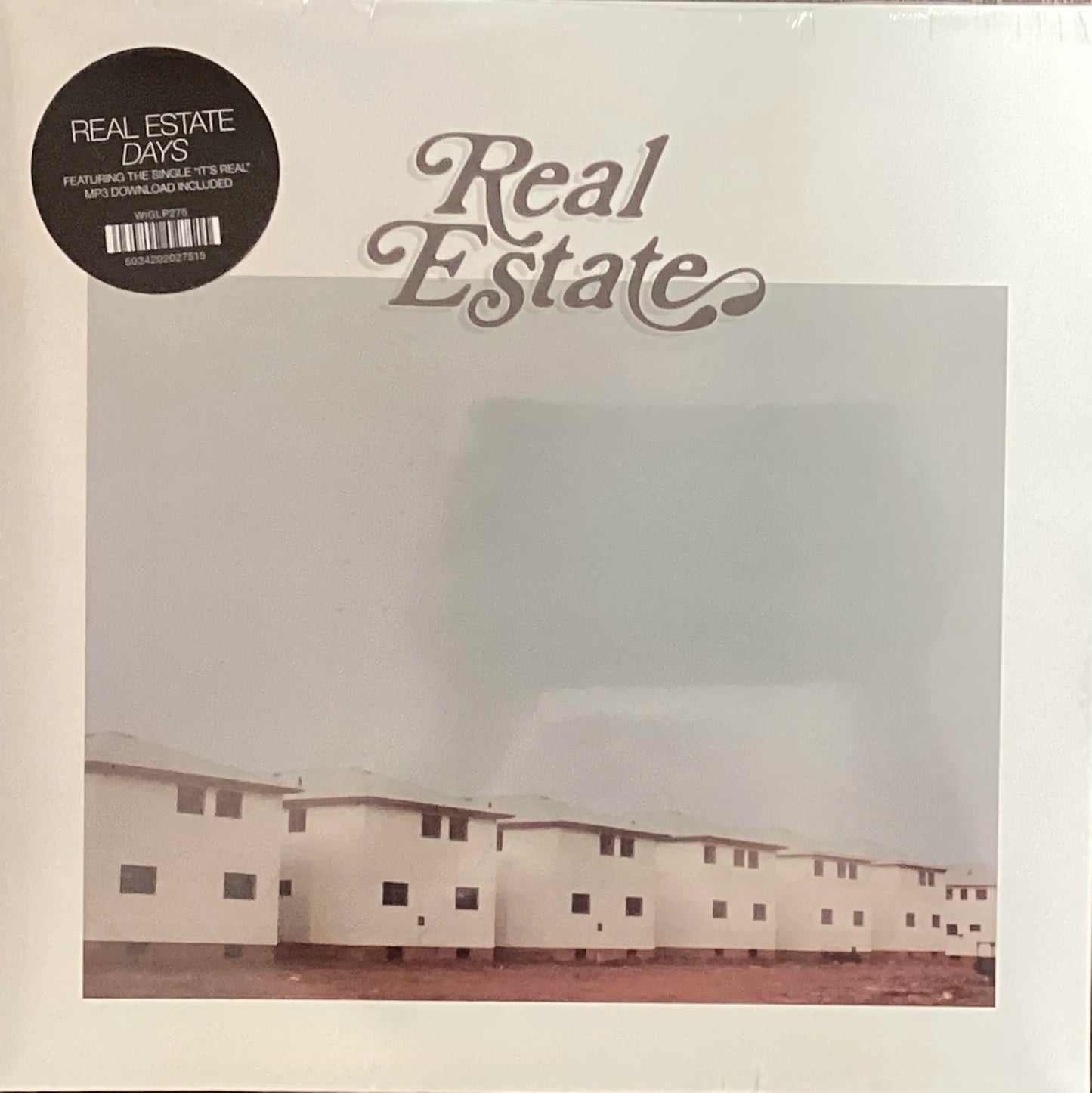 Album cover for 'Real Estate' with a row of houses and text saying 'Real Estate Days'