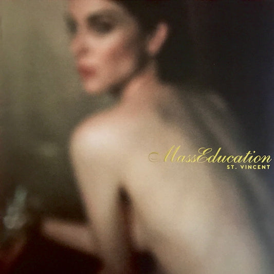 The image features the album cover of "MassEducation" by St. Vincent, showcasing a blurred portrait of a woman in a soft, ethereal light.