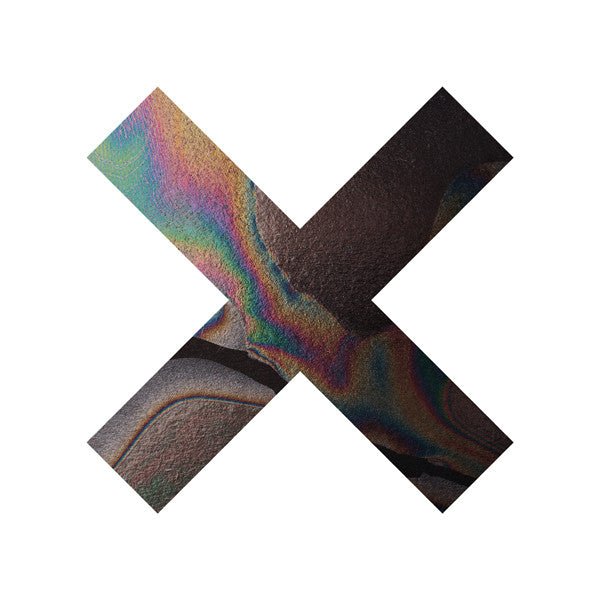 The cover art features a vinyl LP record of The XX's album 'Coexist'. It shows a multicolored, abstract design resembling a rainbow, with the 'XX' symbol in the center, indicating the band's name.