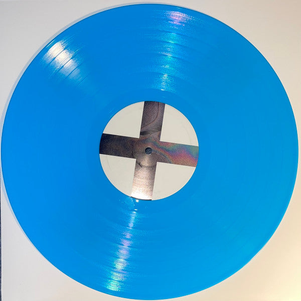 A turquoise colored vinyl LP record of The XX album 'Coexist'.