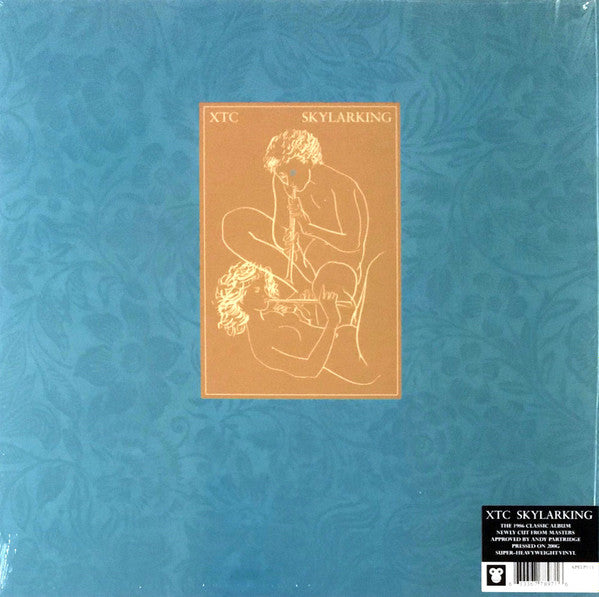 cover of XTC's Skylarking vinyl LP showing a blue patterned design with text and the album title, and an illustration of two figures in a intimate pose.