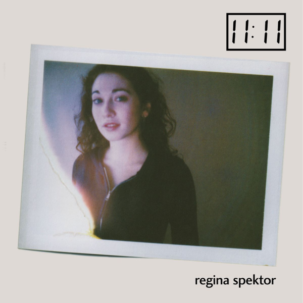 Regina Spektor album cover for '11:11', featuring a Polaroid-style photograph of Regina Spektor against a white background, with the album title and artist name at the bottom.