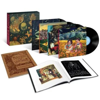 Music box set with vinyl record, book, and artwork on a white background