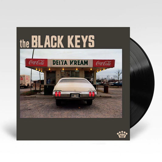 The Black Keys album 'Delta Kream' with a vinyl LP cover featuring a photo of a car in front of a Delta Cream diner.