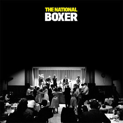 Black and white album cover for The National's Boxer vinyl LP featuring a concert scene with the band on stage and an audience in attendance.