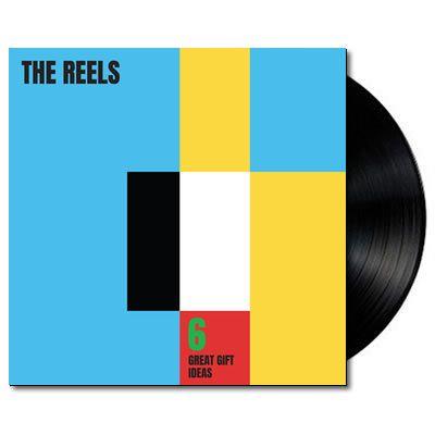 A vinyl LP record of 'The Reels - 6 Great Gift Ideas'. The cover has a colorful geometric design with black, blue, yellow, and red squares.