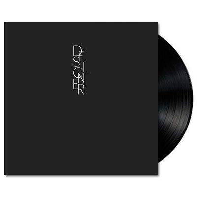 A black vinyl LP record with 'DESIGNER' text on the cover, representing the album by Aldous Harding.