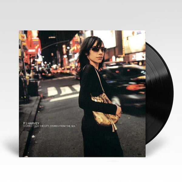 A vinyl LP record of PJ Harvey's album 'Stories From The City, Stories From The Sea' with the artist's photo on the cover.
