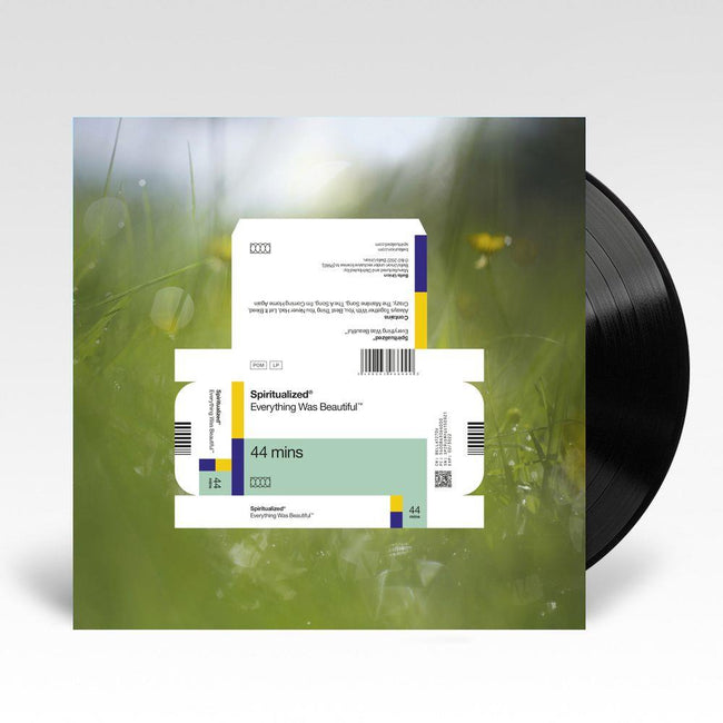 A vinyl LP record of Spiritualized's album 'Everything Was Beautiful' with a white and green cover, depicting a serene landscape