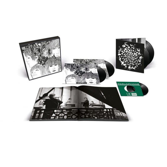 The image shows the contents of the Super Deluxe Vinyl Anniversary Edition of The Beatles' Revolver album, including four LPs, a 7-inch vinyl EP, and a hard-backed book.